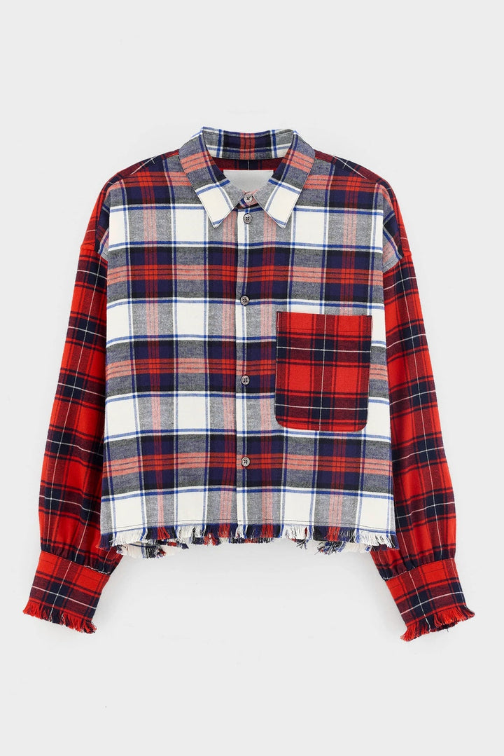 A cropped long-sleeve plaid button-up shirt with a red, white, and navy tartan pattern, featuring a solid red chest pocket and raw, frayed hems.